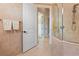 Tiled bathroom with walk-in shower, open door to ensuite, and a neutral color palette at 4409 Crews Ct, Port Charlotte, FL 33952