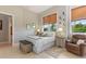 Bright bedroom features a king bed, side table, and a serene view from the window at 4409 Crews Ct, Port Charlotte, FL 33952