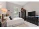 Well-lit bedroom with a king bed, dresser, and a cozy teddy bear on the wardrobe at 4409 Crews Ct, Port Charlotte, FL 33952