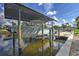 Covered boat lift and boat showcasing waterfront access, offering convenient and protected storage at 4409 Crews Ct, Port Charlotte, FL 33952