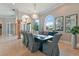 Well-lit dining room showcasing statement mirrors, travertine floors, and elegant decor at 4409 Crews Ct, Port Charlotte, FL 33952