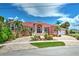 Beautiful Mediterranean-style home with lush landscaping, circular driveway, and grand entryway at 4409 Crews Ct, Port Charlotte, FL 33952