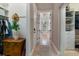 A hallway opens up into a spacious bathroom with a stand alone tub, large window, and stylish fixtures at 4409 Crews Ct, Port Charlotte, FL 33952