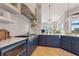 Chef's kitchen with custom blue cabinets, stainless steel appliances, and island sink at 4409 Crews Ct, Port Charlotte, FL 33952