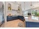 Designer kitchen with marble countertops, custom blue cabinets, and stainless appliances at 4409 Crews Ct, Port Charlotte, FL 33952