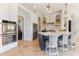 Spacious kitchen with stainless steel double ovens, marbled island with seating, and beautiful travertine flooring at 4409 Crews Ct, Port Charlotte, FL 33952