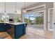 Open kitchen with island seating and sliding glass doors that lead to the outdoors at 4409 Crews Ct, Port Charlotte, FL 33952