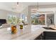 Eat-in kitchen featuring a marbled island with stylish pendant lighting and a lovely view of the lanai at 4409 Crews Ct, Port Charlotte, FL 33952