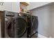 The laundry room features a side-by-side washer and dryer set with a sleek design and plenty of room at 4409 Crews Ct, Port Charlotte, FL 33952