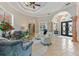 Inviting living room features tray ceiling, travertine floors, and sophisticated seating area at 4409 Crews Ct, Port Charlotte, FL 33952