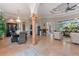 Open concept living and dining area featuring tile floors, decorative columns, and elegant decor at 4409 Crews Ct, Port Charlotte, FL 33952