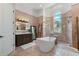 This main bathroom is complete with dual sinks, a glass-encased shower, and a stand alone tub at 4409 Crews Ct, Port Charlotte, FL 33952