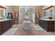 The main bathroom boasts dual sinks, a stand alone tub, and a separate shower in a brightly tiled room at 4409 Crews Ct, Port Charlotte, FL 33952
