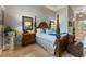 The main bedroom has a stylish wooden frame bed, side tables, and large chest in this spacious home at 4409 Crews Ct, Port Charlotte, FL 33952