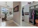 An open hallway leads to the main bedroom and a custom walk-in closet with shelving and storage at 4409 Crews Ct, Port Charlotte, FL 33952