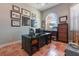 Home office featuring custom desk, brick flooring, and natural light from large window at 4409 Crews Ct, Port Charlotte, FL 33952