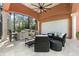 Outdoor kitchen and entertaining area with grill, bar seating, and cozy lounge space with lots of seating at 4409 Crews Ct, Port Charlotte, FL 33952