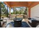 Outdoor kitchen and entertaining area with grill, bar seating, and cozy lounge space with lots of seating at 4409 Crews Ct, Port Charlotte, FL 33952