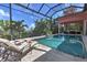 Screened in outdoor pool and patio area with lounge chairs, perfect for relaxing and entertaining guests at 4409 Crews Ct, Port Charlotte, FL 33952