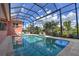 Enclosed outdoor pool, patio area, and lush landscaping that offers relaxation and privacy at 4409 Crews Ct, Port Charlotte, FL 33952