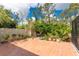 Paver patio with potted plants surrounded by a white fence, set under a sunny sky at 4443 Abcor Rd, North Port, FL 34286