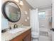 Bathroom with vanity sink, granite countertop, framed mirror and shower-tub combo at 4443 Abcor Rd, North Port, FL 34286