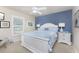 Bedroom with an accent wall, side tables with lamps, and a window with plantation shutters at 4443 Abcor Rd, North Port, FL 34286