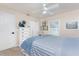 Comfortable bedroom featuring natural light, white dresser, and ceiling fan at 4443 Abcor Rd, North Port, FL 34286