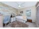 Cozy bedroom featuring a decorative accent wall, neutral tones and plenty of natural light at 4443 Abcor Rd, North Port, FL 34286