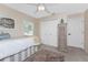 Comfortable bedroom featuring a ceiling fan, neutral decor, and plenty of closet space at 4443 Abcor Rd, North Port, FL 34286