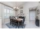 Cozy dining area featuring tile floors, window with shutters, and traditional-style chandelier at 4443 Abcor Rd, North Port, FL 34286
