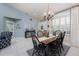 Light-filled dining area with tile floors, charming window and traditional dining set at 4443 Abcor Rd, North Port, FL 34286
