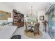 Open concept dining space featuring a glass table, wicker chairs, and seamless connection to the living area at 4443 Abcor Rd, North Port, FL 34286