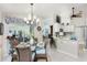 Dining area showcasing a glass table, wicker chairs, chandelier, and kitchen access at 4443 Abcor Rd, North Port, FL 34286