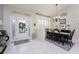 Bright foyer with tile floors, chandelier, front door and dining area, creating an inviting atmosphere at 4443 Abcor Rd, North Port, FL 34286