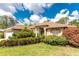 Charming one-story home with a well-maintained lawn, lush landscaping and an attached garage at 4443 Abcor Rd, North Port, FL 34286