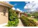 Charming one-story home with a well-maintained lawn, lush landscaping and an attached garage at 4443 Abcor Rd, North Port, FL 34286