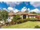 Charming one-story home with a well-maintained lawn, lush landscaping and an attached garage at 4443 Abcor Rd, North Port, FL 34286
