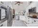 Modern kitchen featuring white cabinets, stainless steel appliances, and an open concept design at 4443 Abcor Rd, North Port, FL 34286