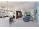 Open-concept living area with tile floors, high ceilings, and view to the backyard at 4443 Abcor Rd, North Port, FL 34286