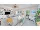 Inviting living room with coastal decor, comfortable seating, a ceiling fan, and ample natural light at 4443 Abcor Rd, North Port, FL 34286