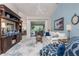Bright living room featuring large blue patterned rug, built-in shelving unit, and sliding glass doors to lanai at 4443 Abcor Rd, North Port, FL 34286