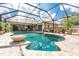 Beautiful screened-in pool with a tranquil water feature and access to the outdoor seating area at 4443 Abcor Rd, North Port, FL 34286