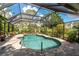 Gorgeous screened-in pool surrounded by lush landscaping offering a private and serene retreat at 4443 Abcor Rd, North Port, FL 34286