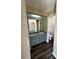 Functional bathroom with a single sink vanity, mirror, and toilet, adjacent to another room at 5498 Montego Ln, Port Charlotte, FL 33981