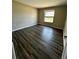 Cozy bedroom with hardwood floors, neutral paint, and bright window views at 5498 Montego Ln, Port Charlotte, FL 33981