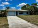 Charming single-story home with a well-manicured lawn and a classic architectural design and a driveway at 5498 Montego Ln, Port Charlotte, FL 33981