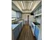 Galley kitchen with essential appliances, wood-look floors, and ample cabinet space for convenient meal preparation at 5498 Montego Ln, Port Charlotte, FL 33981