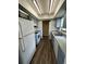 Galley kitchen with essential appliances, wood-look floors, and ample cabinet space for convenient meal preparation at 5498 Montego Ln, Port Charlotte, FL 33981
