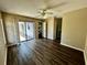 Inviting living room with natural light, wood flooring, ceiling fan and a sliding glass door to the outside at 5498 Montego Ln, Port Charlotte, FL 33981
